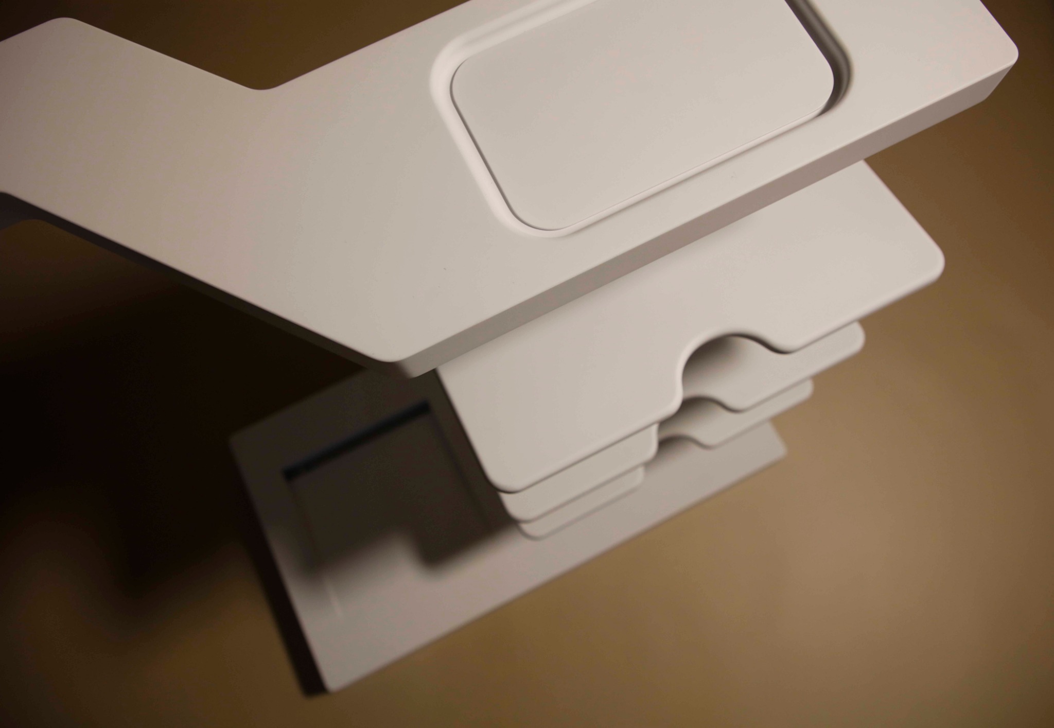 Close detail of ENTRY layered shelf rhythm and rounded edge treatment.