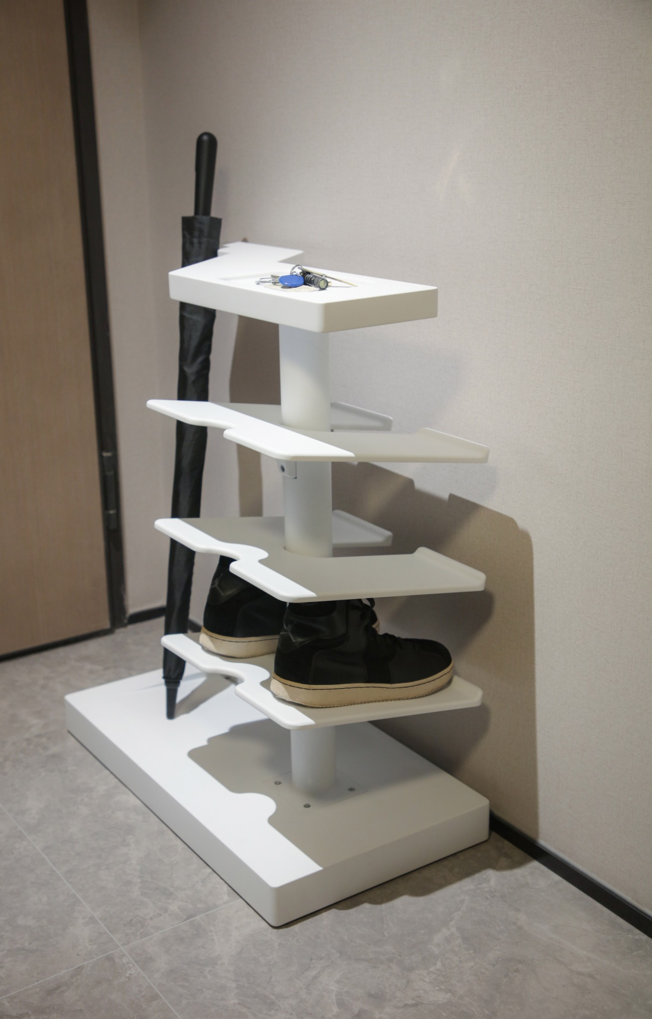 ENTRY installed in an entryway with shoes, umbrella, and keys placed on the object.