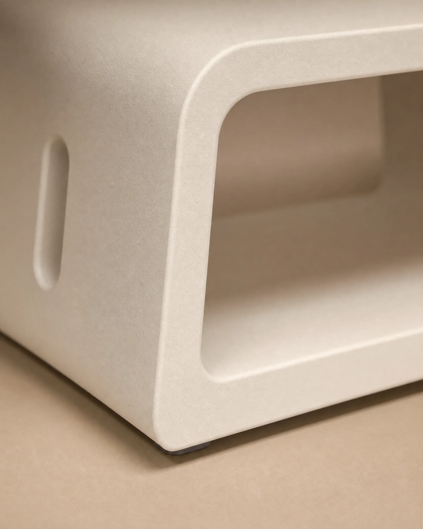 Close detail of Threshold Chair surface, rounded corner, and side guidance slot.